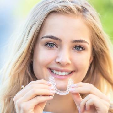 girl showing her clear aligners